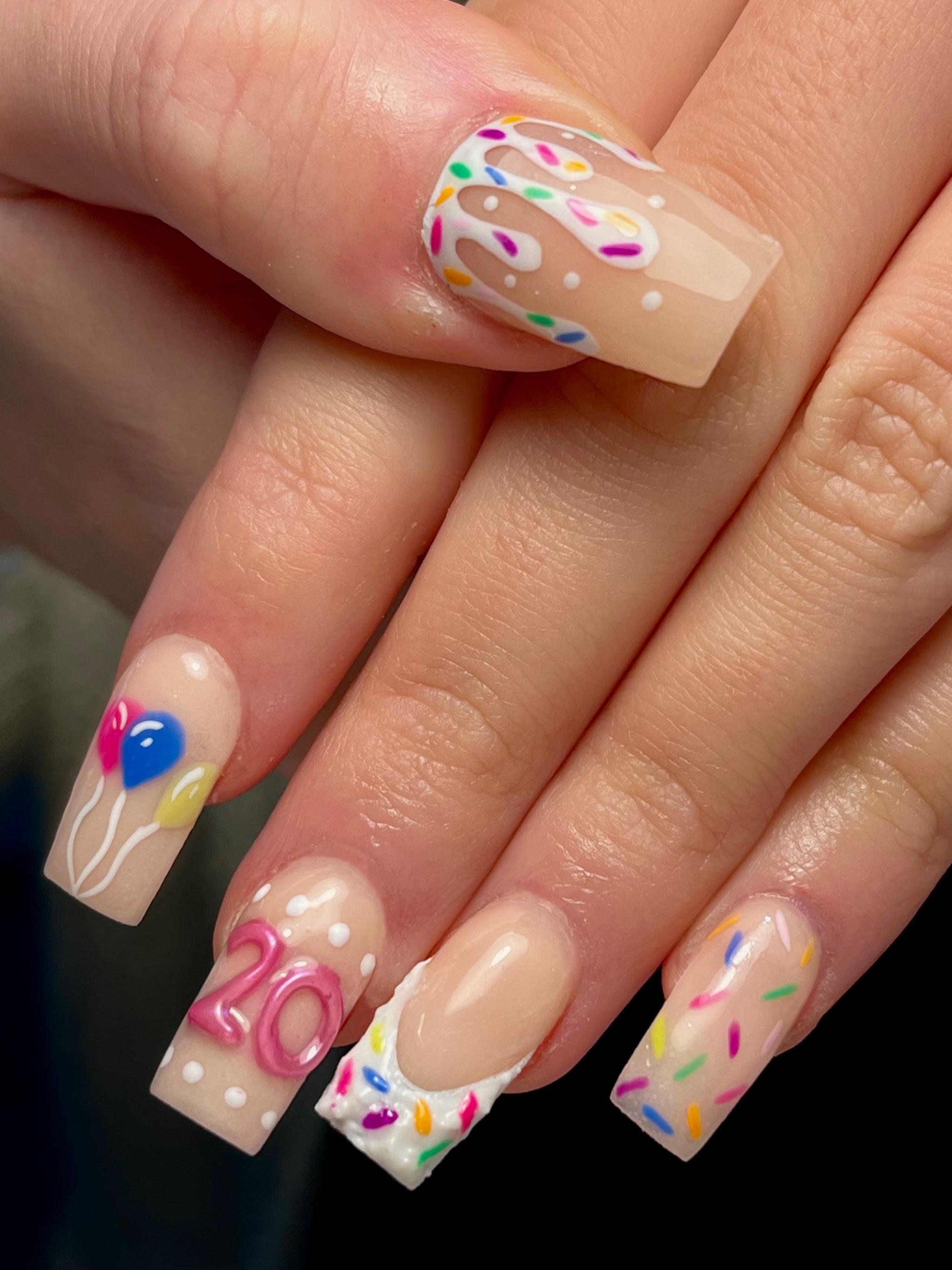 Nude acrylics with sprinkles, balloons and a 20 for a birthday