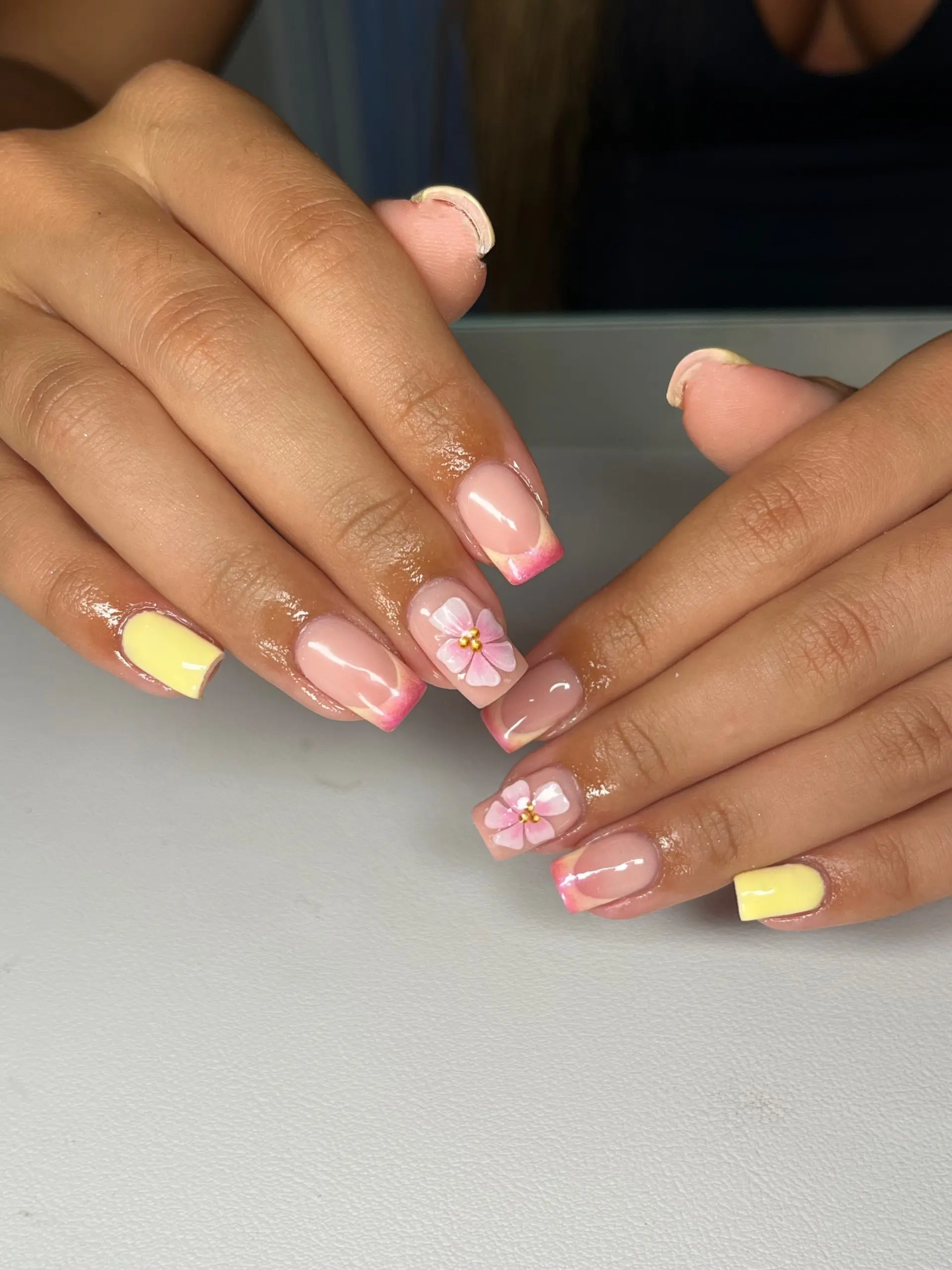 Short nude nails with pink French tips and flower art
