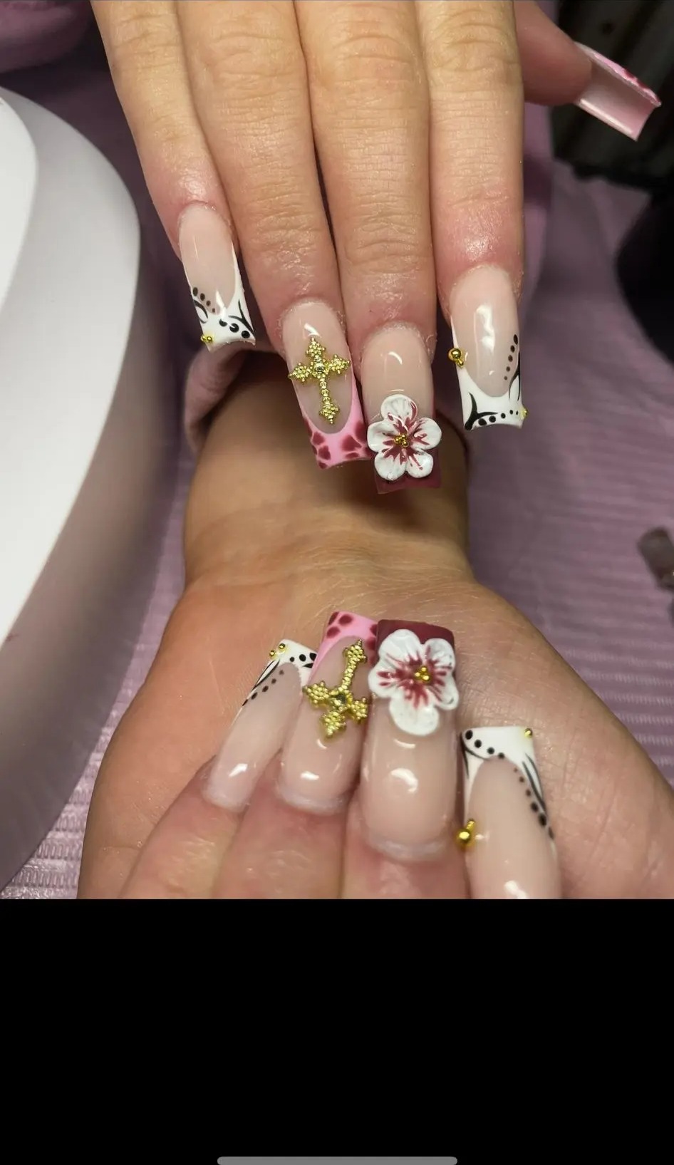 Long nude acrylics with pink 3D flowers and gold charms